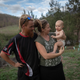 Jamille Noxgray, Rachel Noonan and their daughter Manuka, who are now living in a tent after their home was destroyed, are pictured on January 14, 2020 in Wytaliba, Australia.
